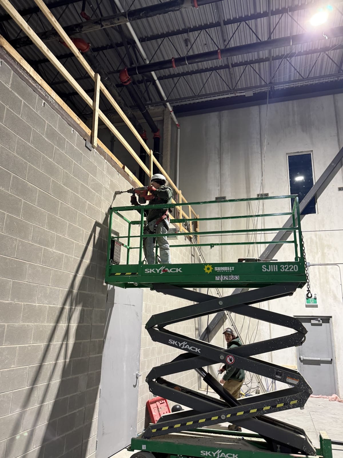 Overhead pipe work from a scissor lift — Commercial & Industrial project by Glen The Plumber