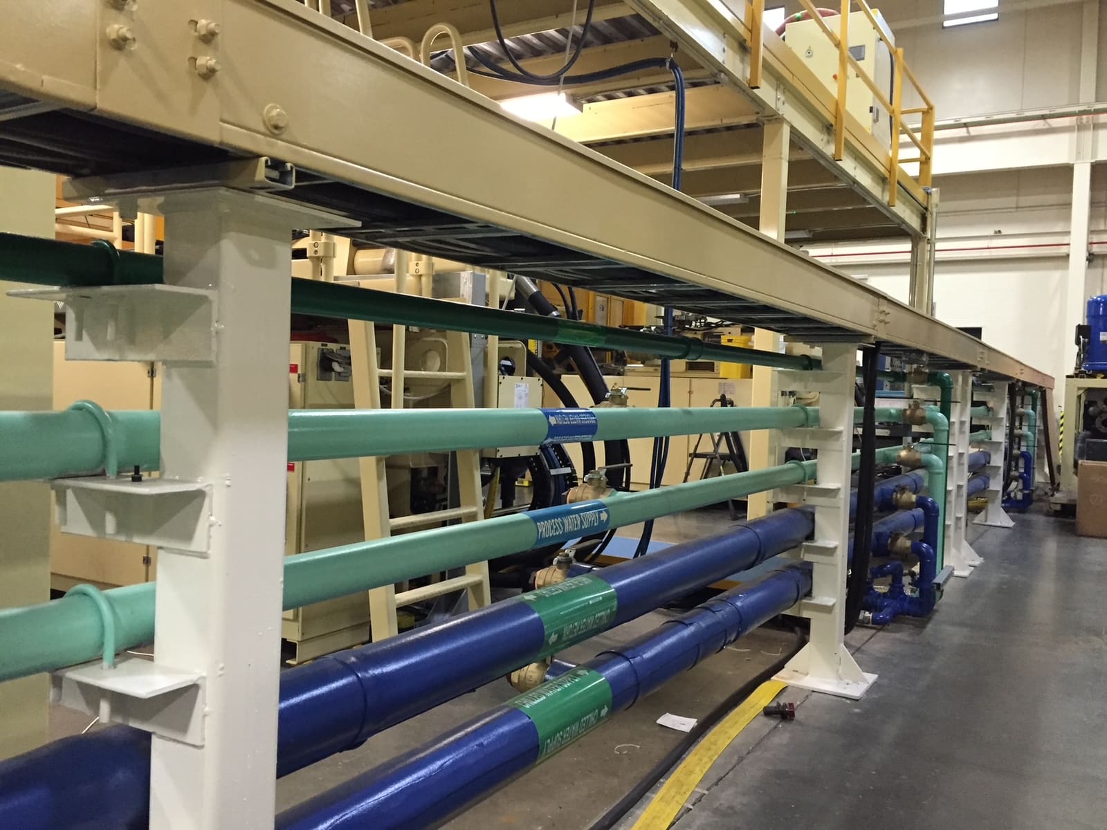 Labelled industrial process piping installed by Glen The Plumber in a production facility