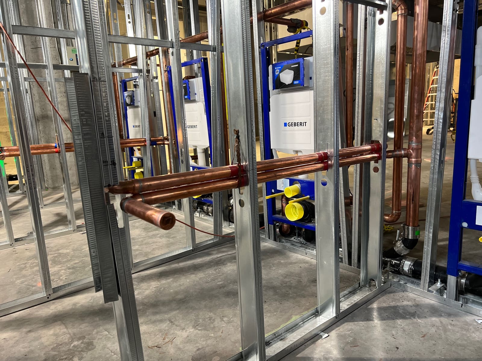Geberit in-wall carriers in metal stud framing — Commercial & Industrial project by Glen The Plumber