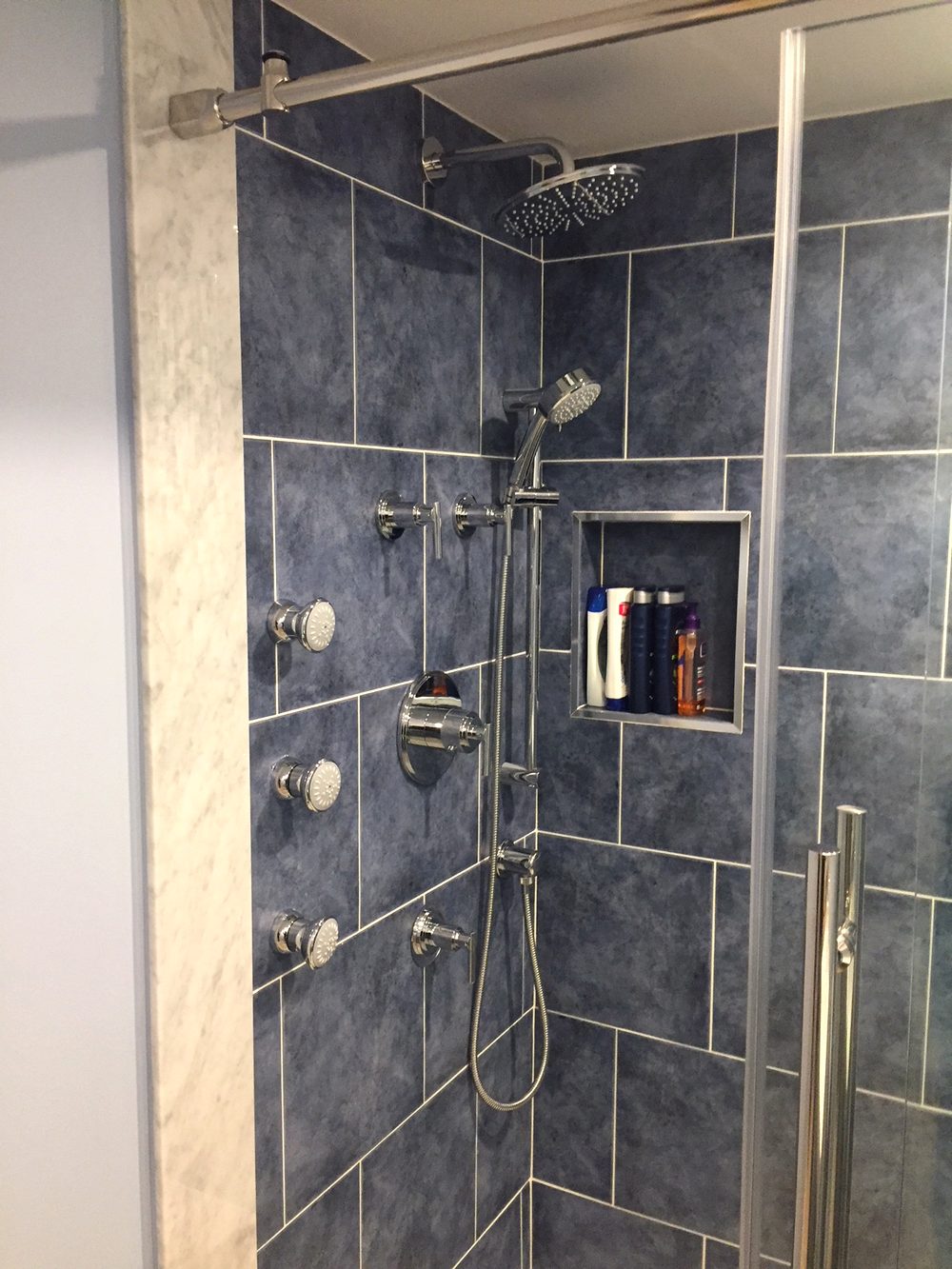 Finished custom tile shower with rain head and body sprays